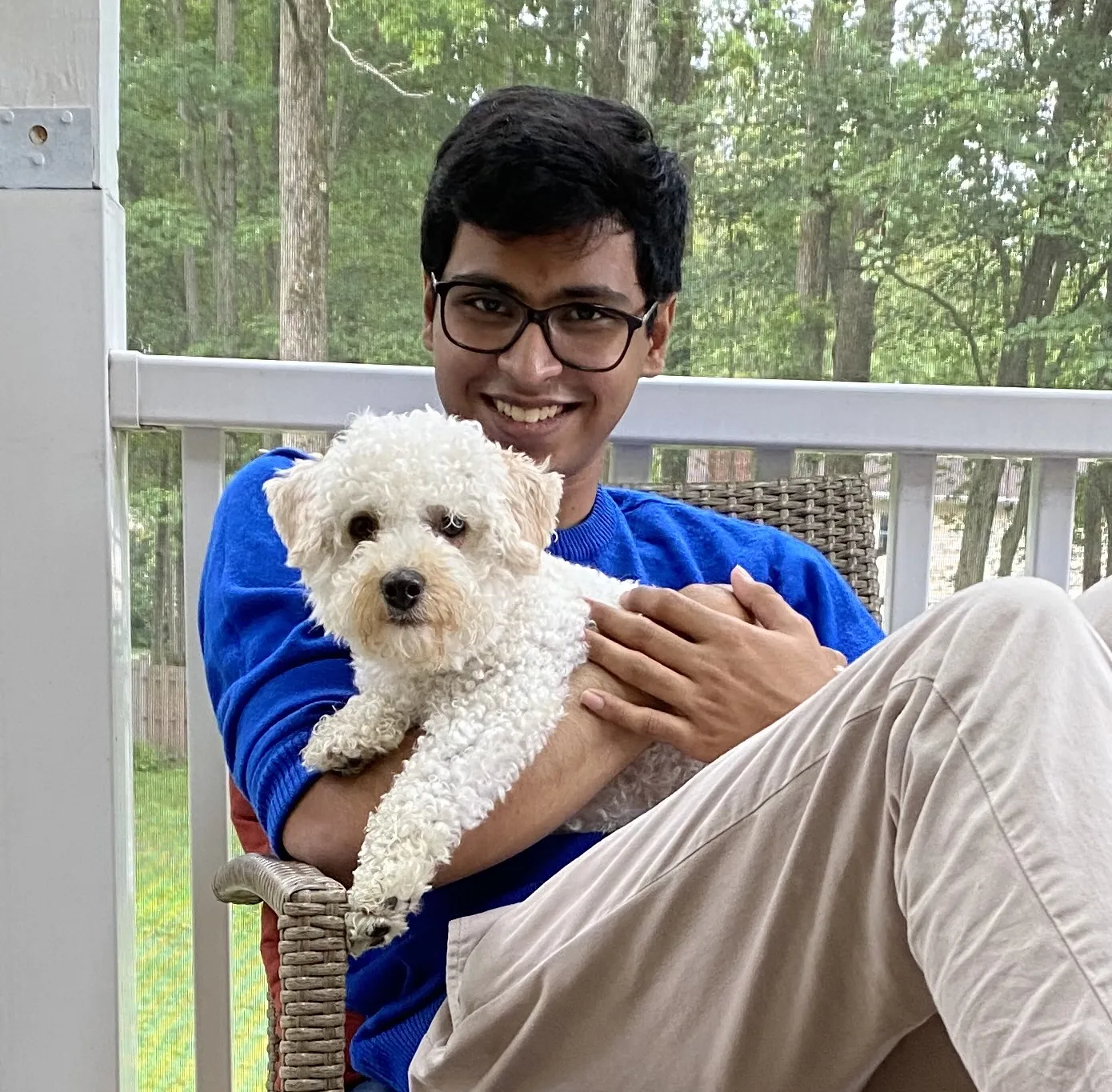 Profile picture of me sitting with a little doggo.